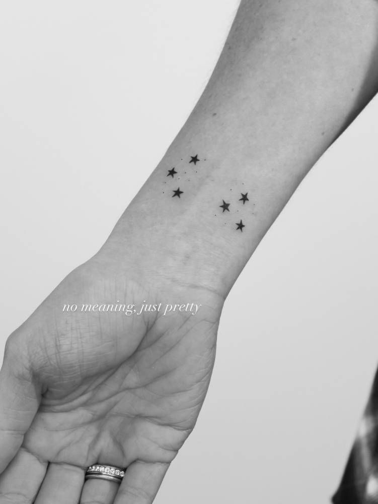 Minimalist stars tattoo located on the wrist.