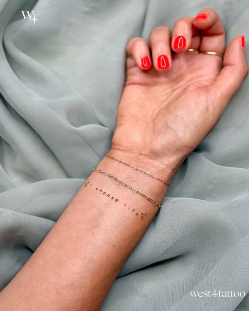 "I choose life" lettering tattoo located on the wrist.