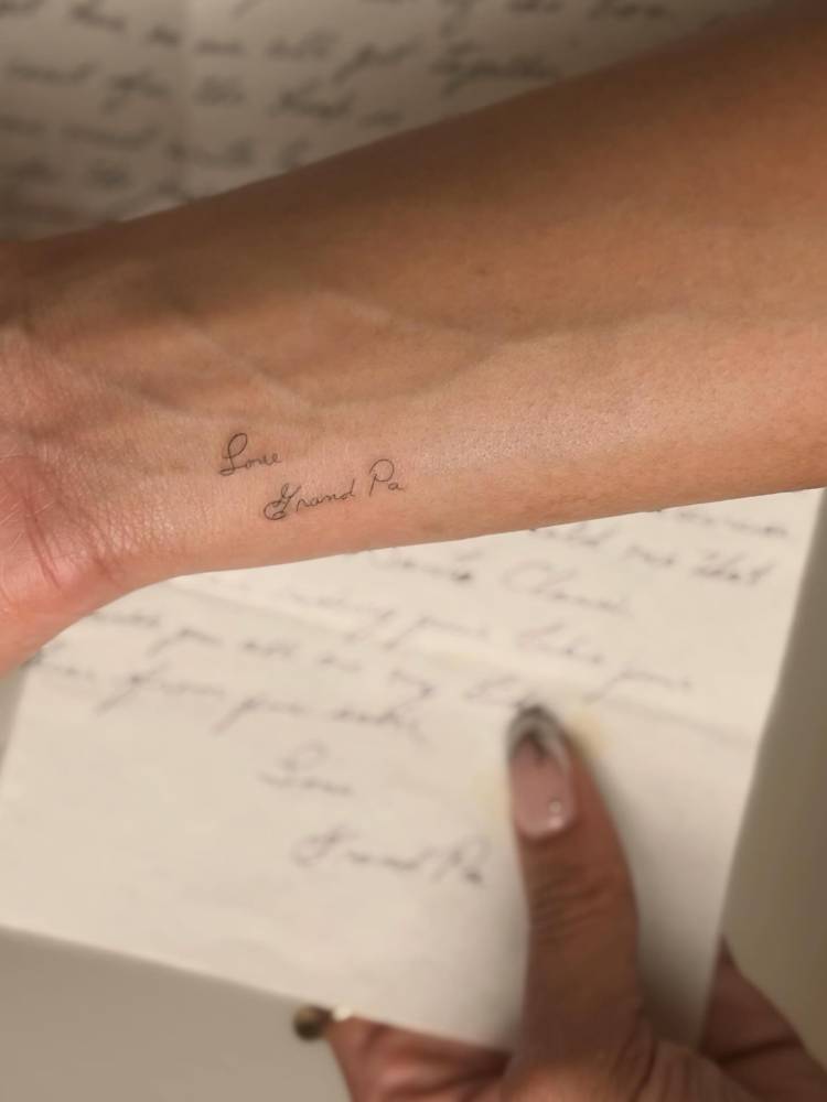 “Love, grandpa” lettering tattoo located on the wrist.