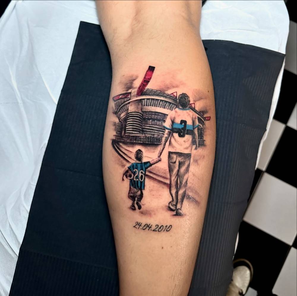 Inter Milan tattoo located on the calf, done in illustrative style.