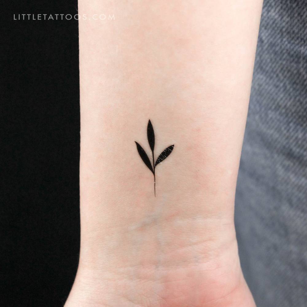 Small sprout temporary tattoo in minimalistic style.