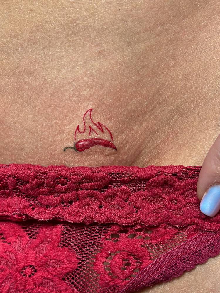 Flaming red chili pepper tattoo in illustrative style.