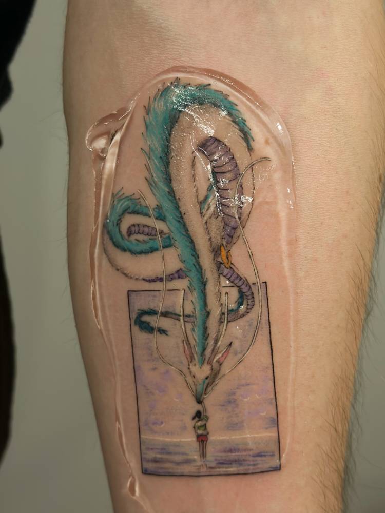 Cartoon style Haku tattoo located on the inner forearm.