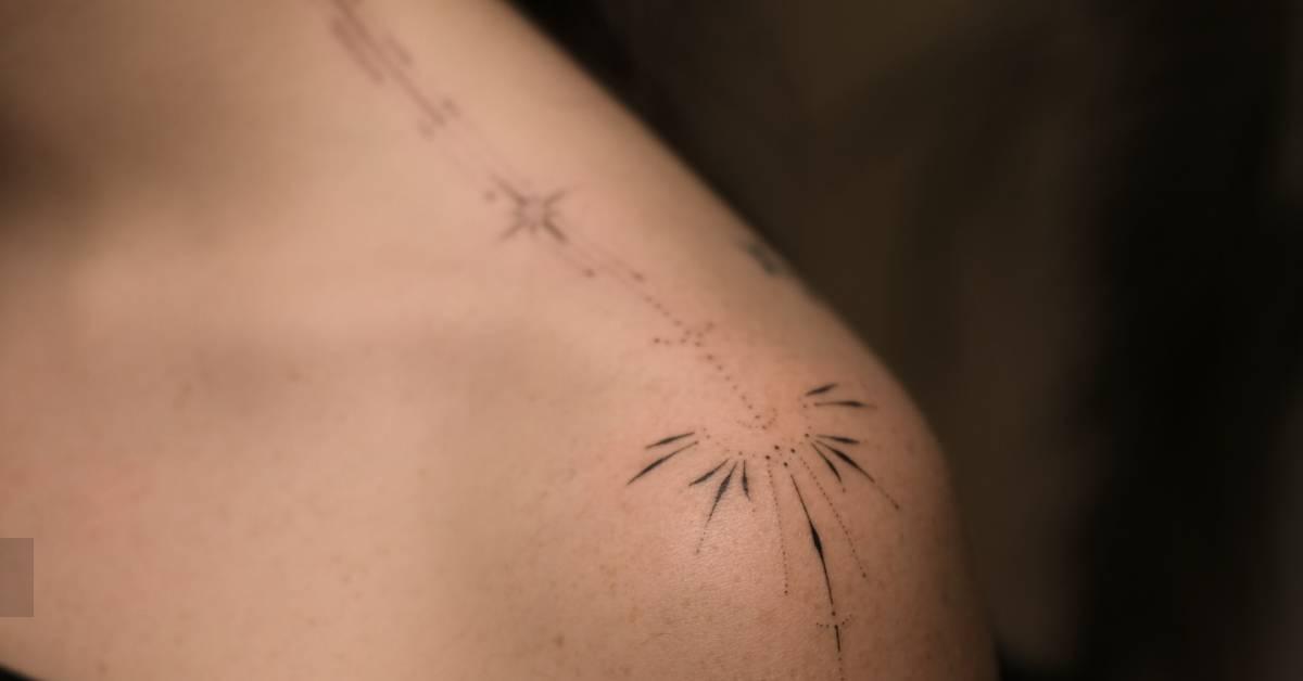 Little ornamental tattoo hand poked on the shoulder.