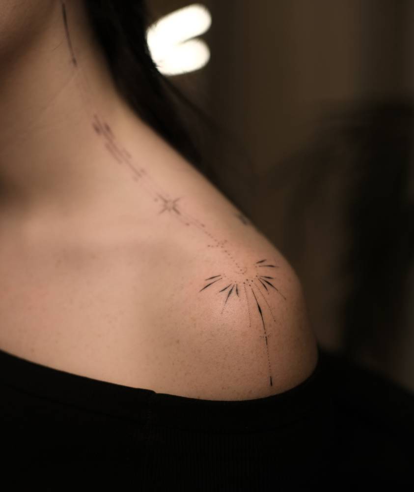 Little ornamental tattoo hand poked on the shoulder.
