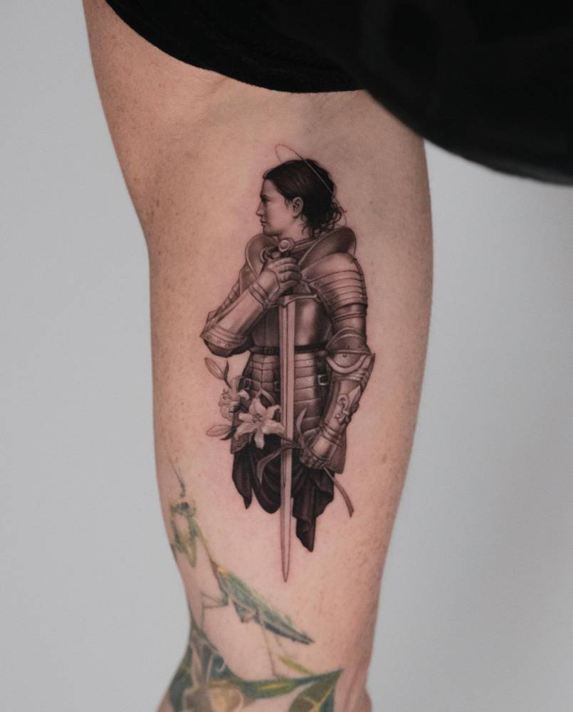 Joanna d’Arc tattoo in micro-realistic style located on the inner arm.
