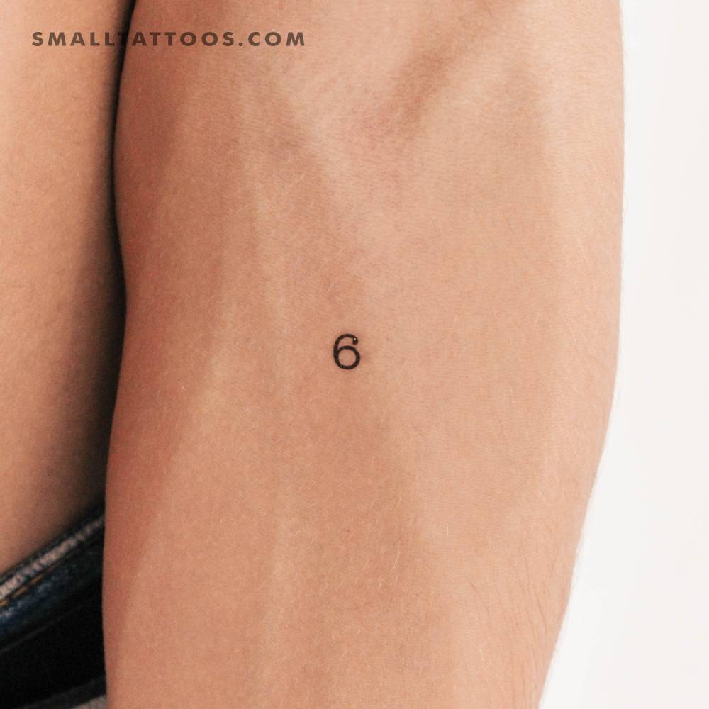 Number "6" temporary tattoo located on the inner forearm.