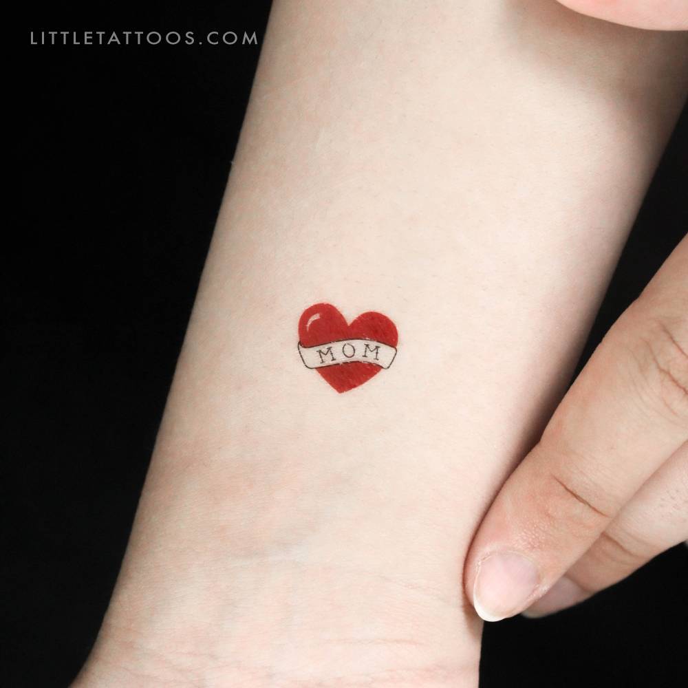 Small heart with "mom" banner temporary tattoo.