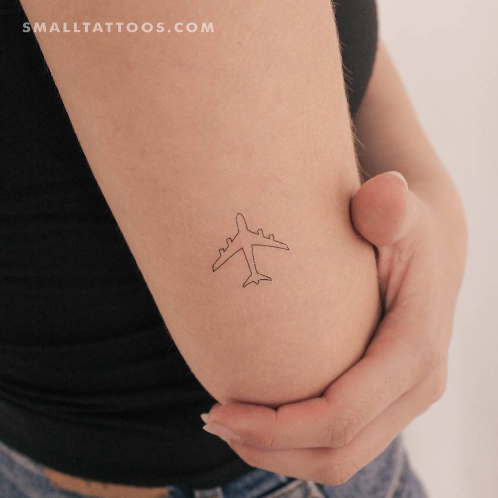 Airplane outline temporary tattoo in fine line style.