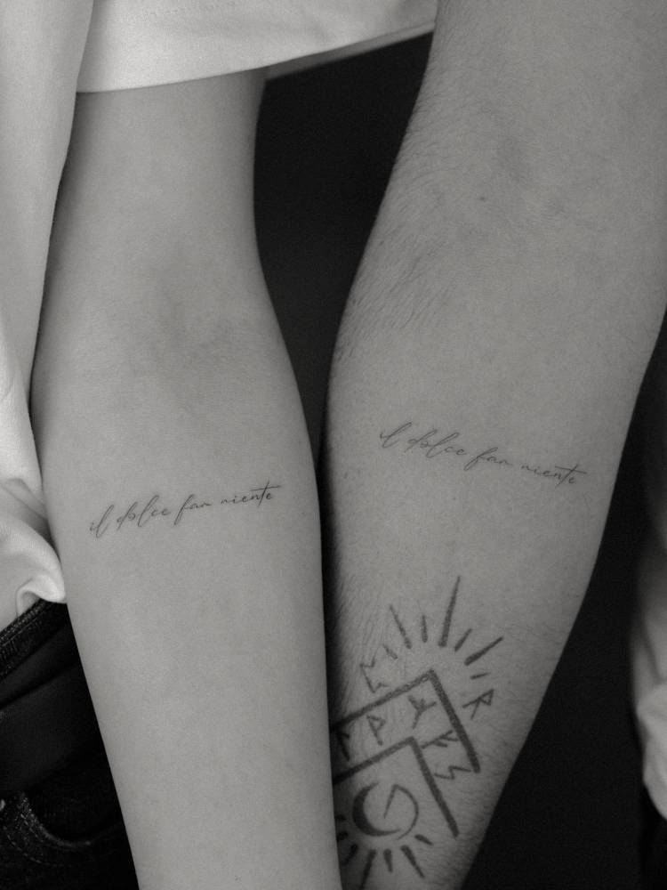 Matching "Il dolce far niente" lettering tattoo for couple.
