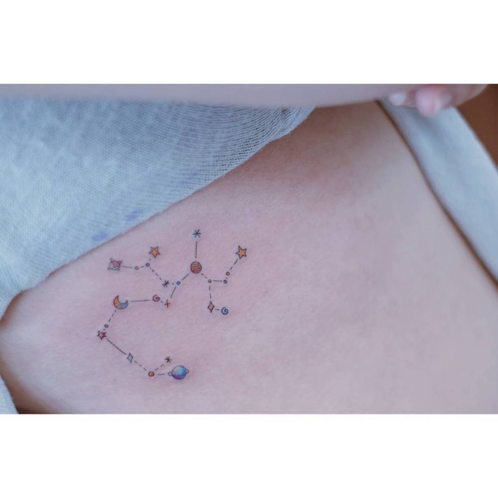 Illustrative style Sagittarius constellation tattoo located on the rib.