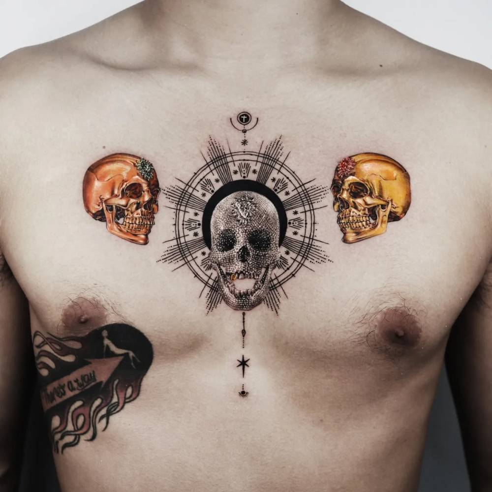 Graphic style skulls tattoo located on the chest.
