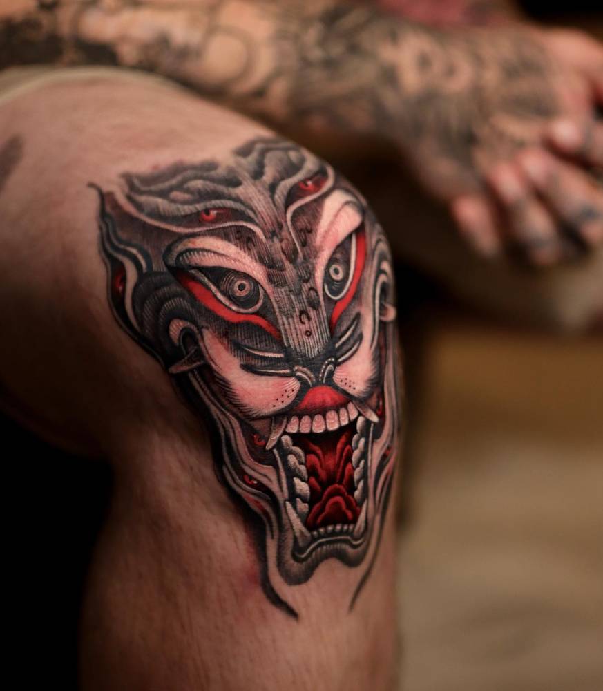 Oriental style Yokai tattoo located on the knee.