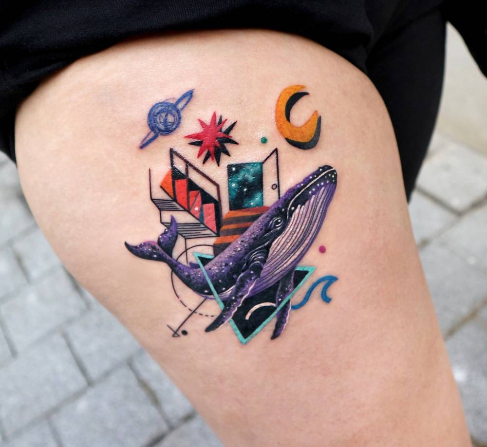 Whale tattoo in graphic style located on the thigh.