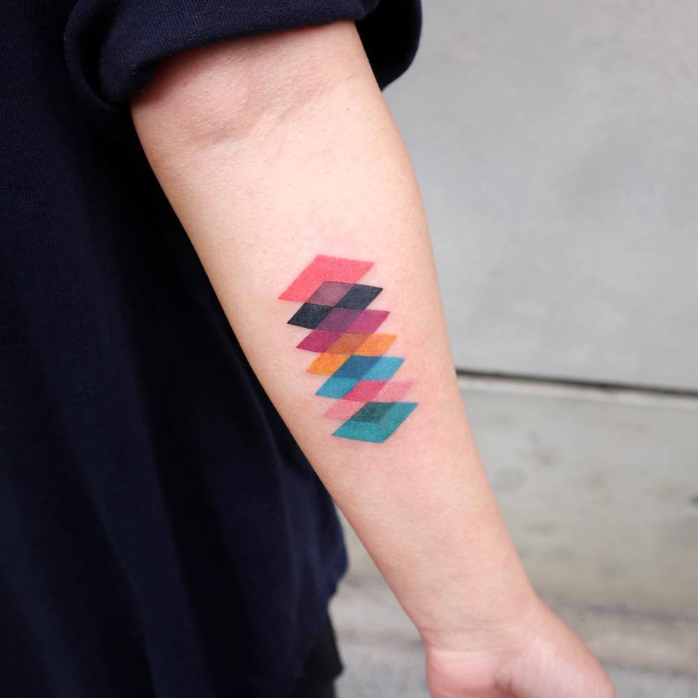Geometric style squares tattoo located on the inner forearm.