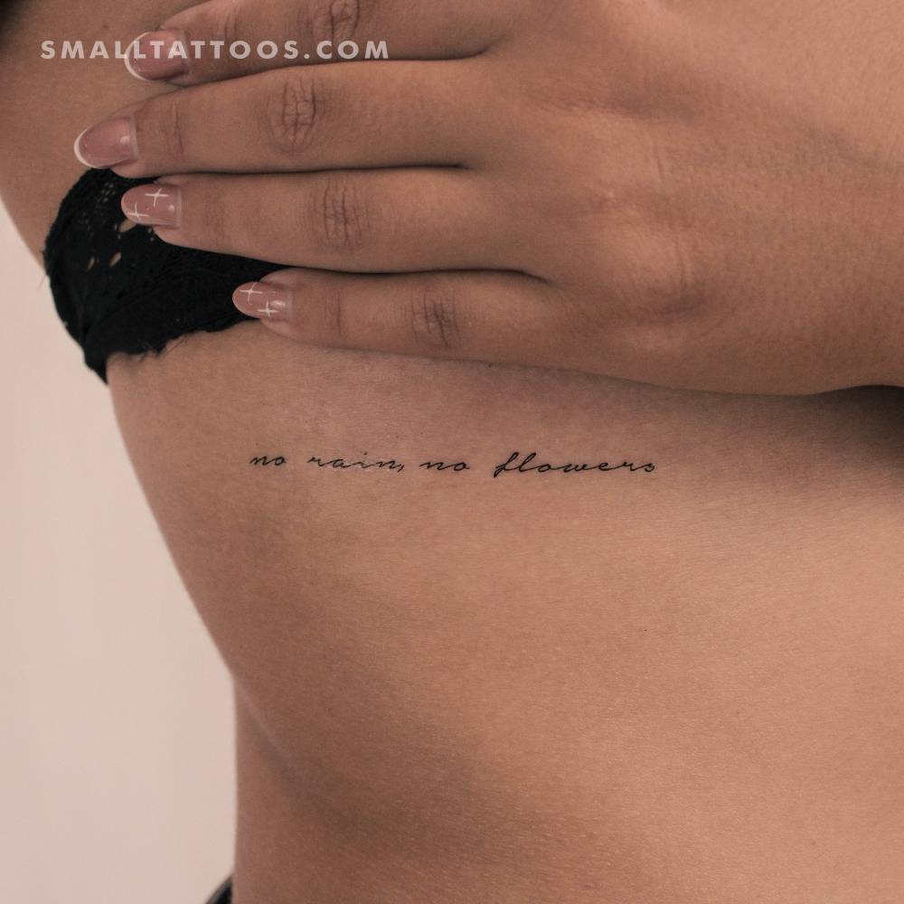 "No rain, no flowers" handwritten font temporary tattoo located on the rib.