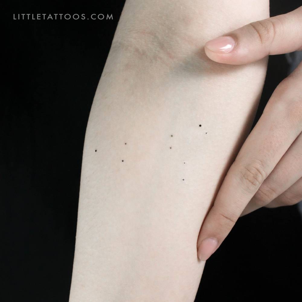 Minimalist style Leo constellation temporary tattoo located on the inner forearm.