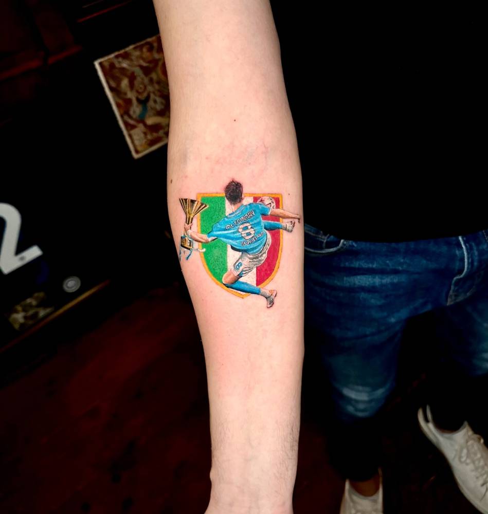 Scott McTominay tattoo located on the inner forearm, micro-realistic style.