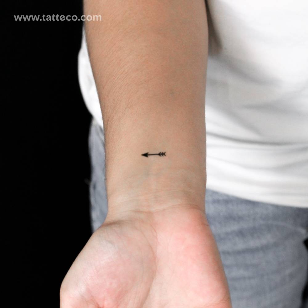 Tiny arrow semi-permanent tattoo placed on the wrist.