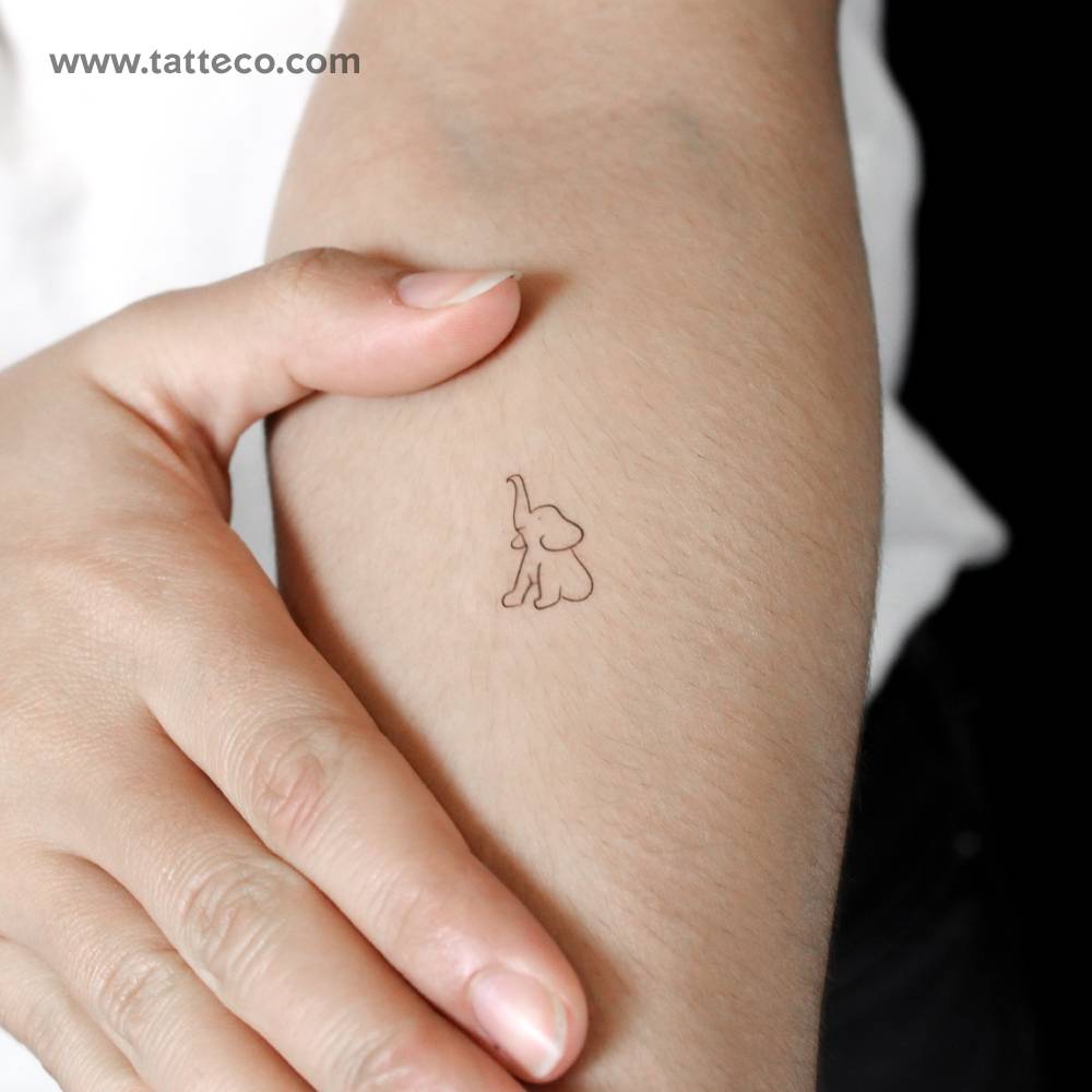 Fine line style elephant sitting semi-permanent tattoo.