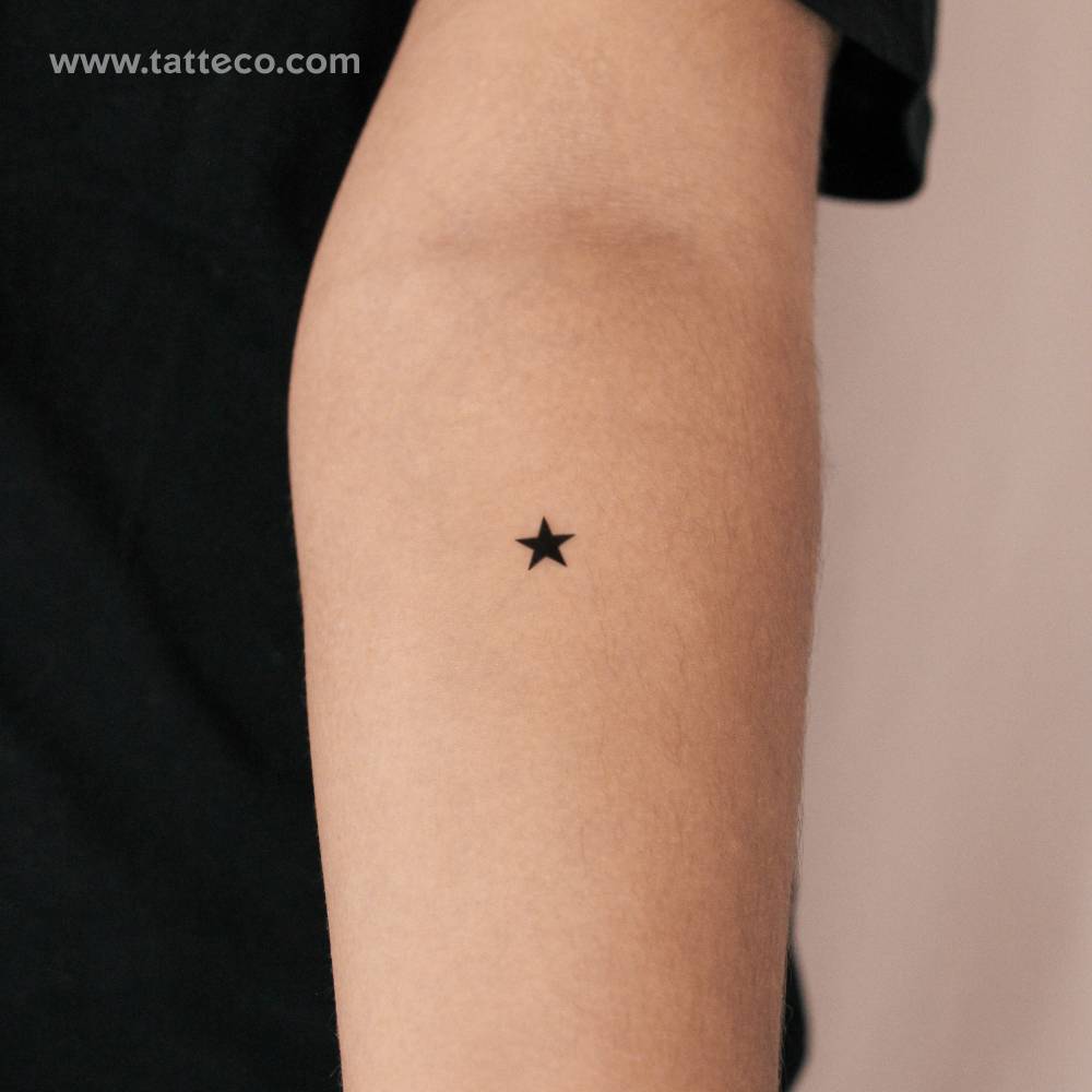 Black star semi-permanent tattoo located on the inner forearm.