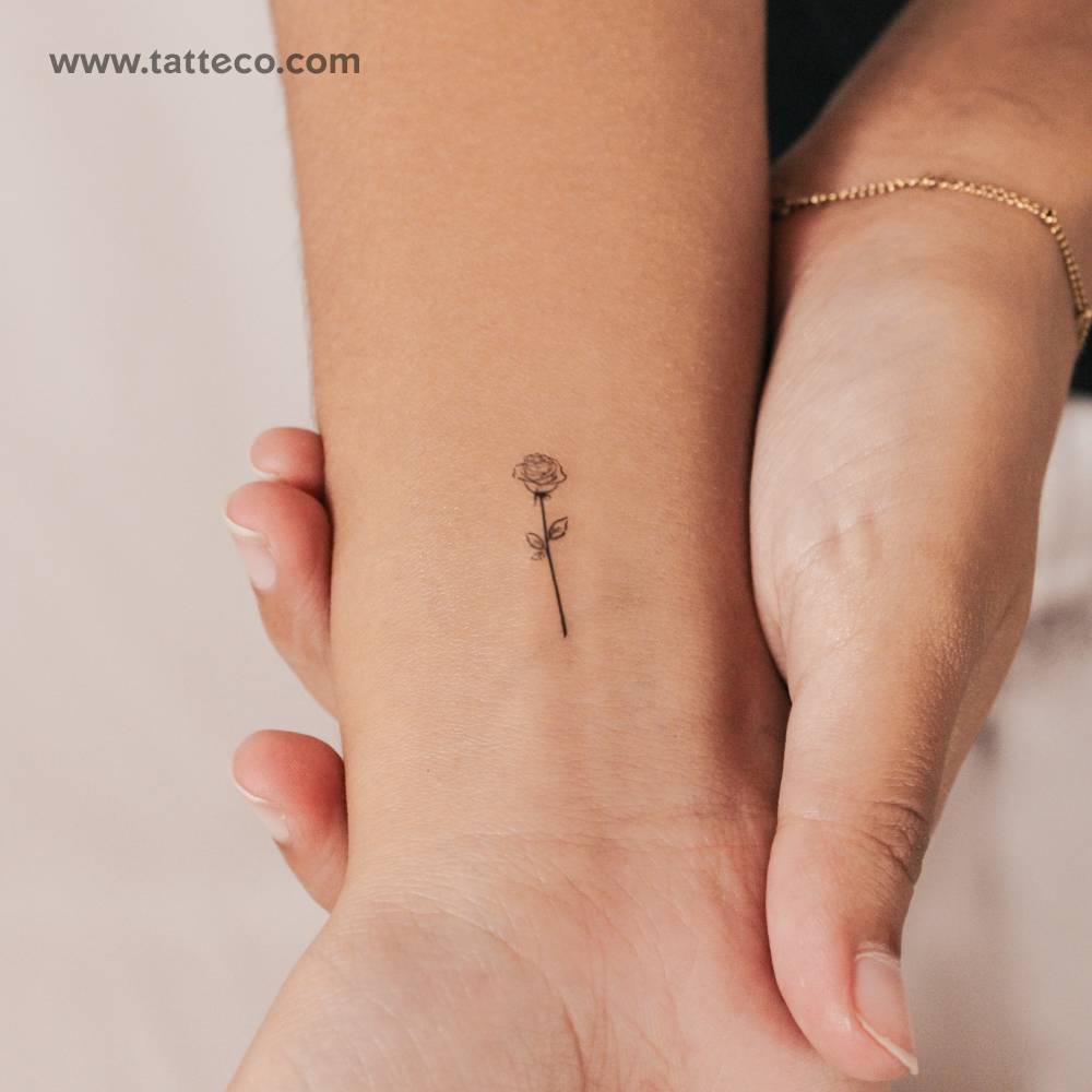 Small fine line rose semi-permanent tattoo located on the wrist.