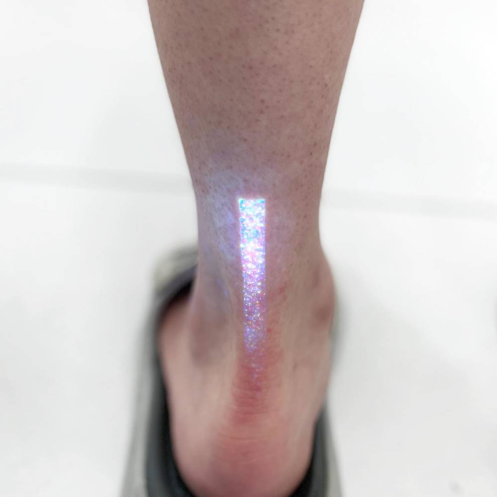 Glitter effect tattoo located on the achilles.