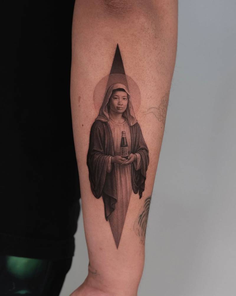María Orosa tattoo located on the forearm, micro-realistic style.