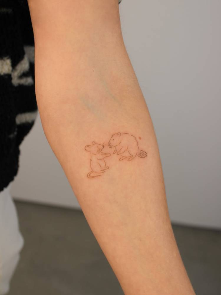 Mouse and beaver tattoo in fine line style located on the inner forearm.