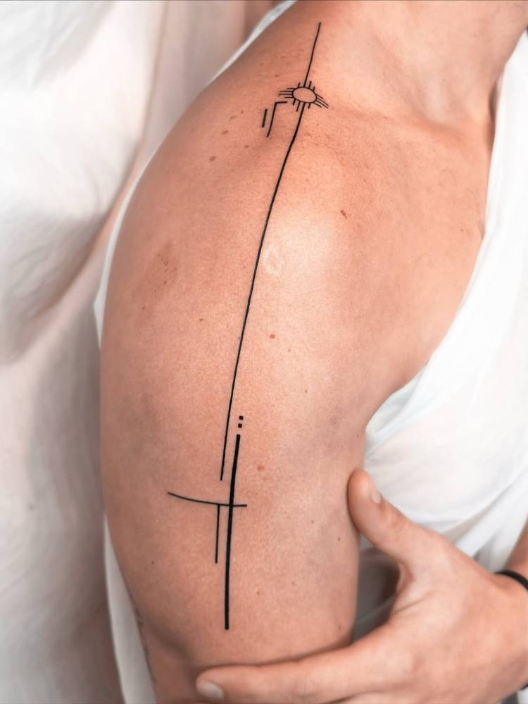 Geometric style tattoo design located on the shoulder.