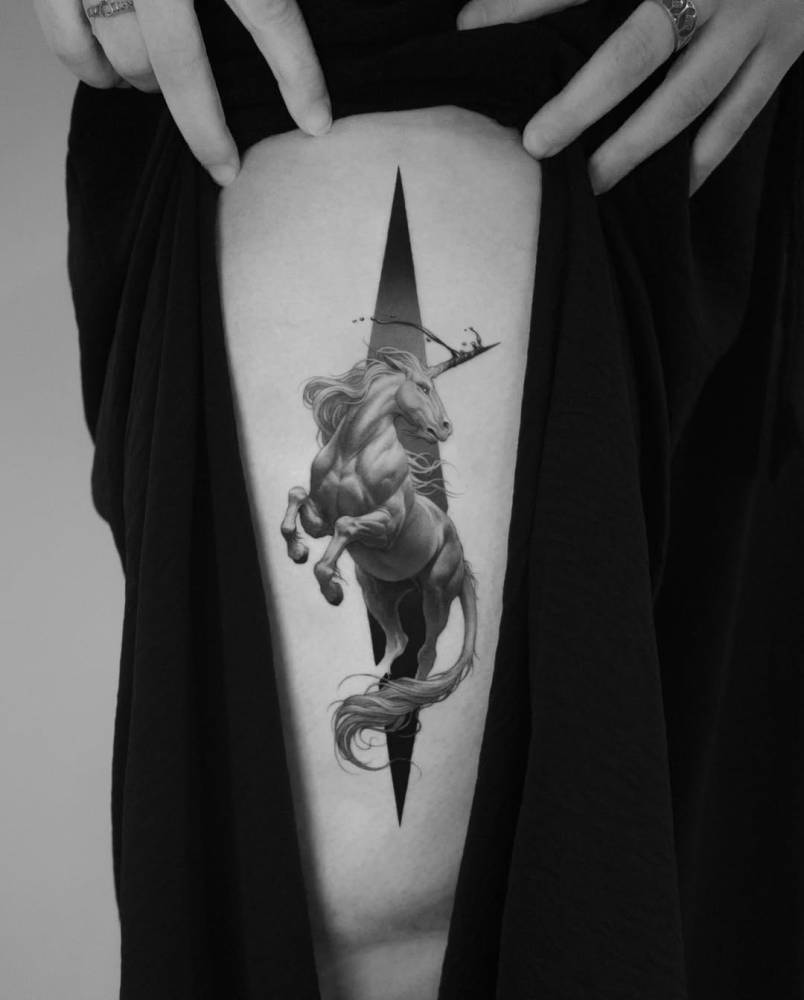 Micro-realistic style unicorn tattoo placed on the thigh.