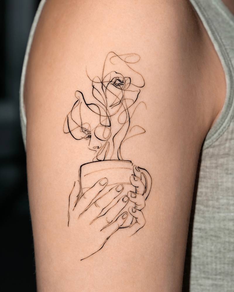 Teacup tattoo located on the upper arm, sketch work style.