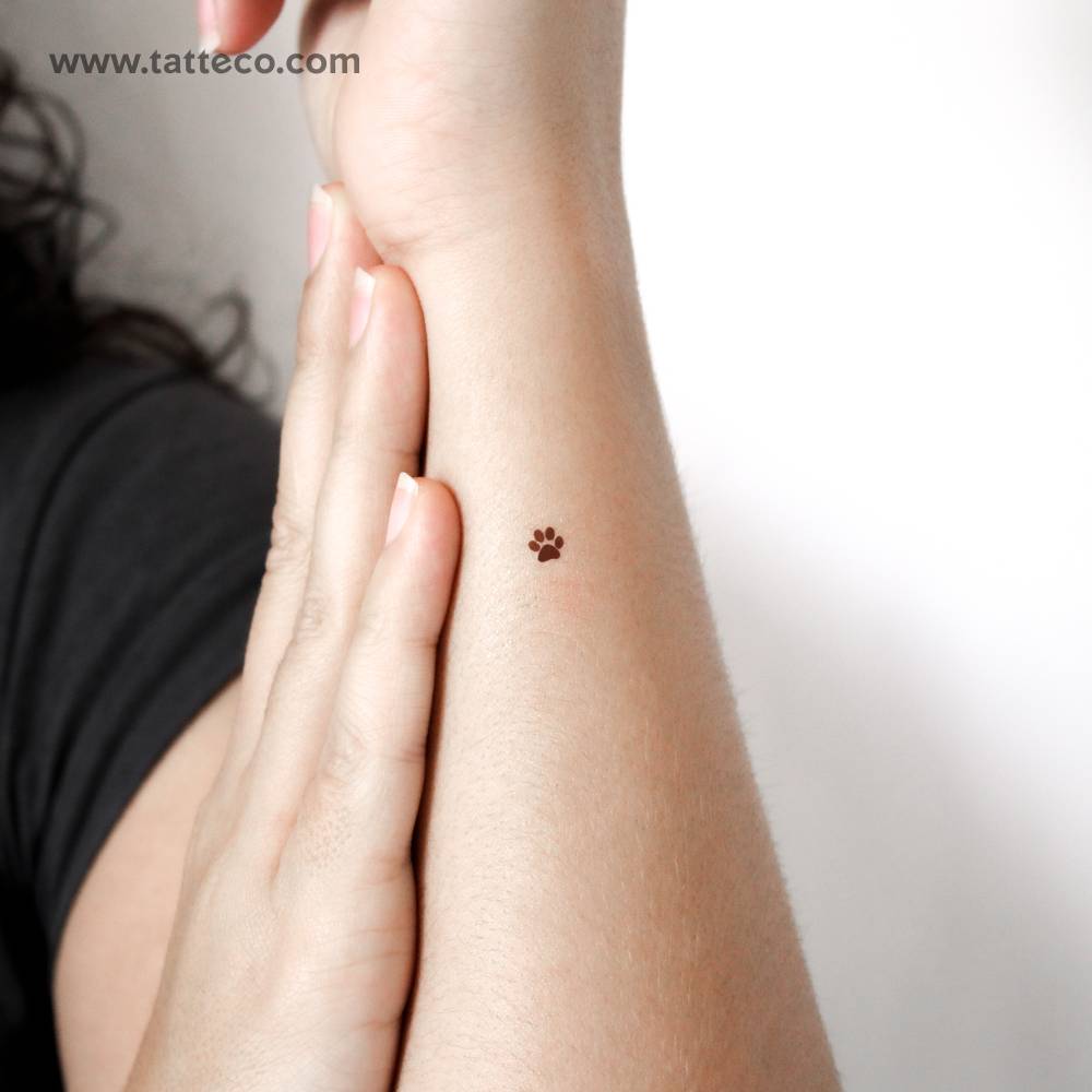 Brown paw print temporary tattoo located on the wrist.