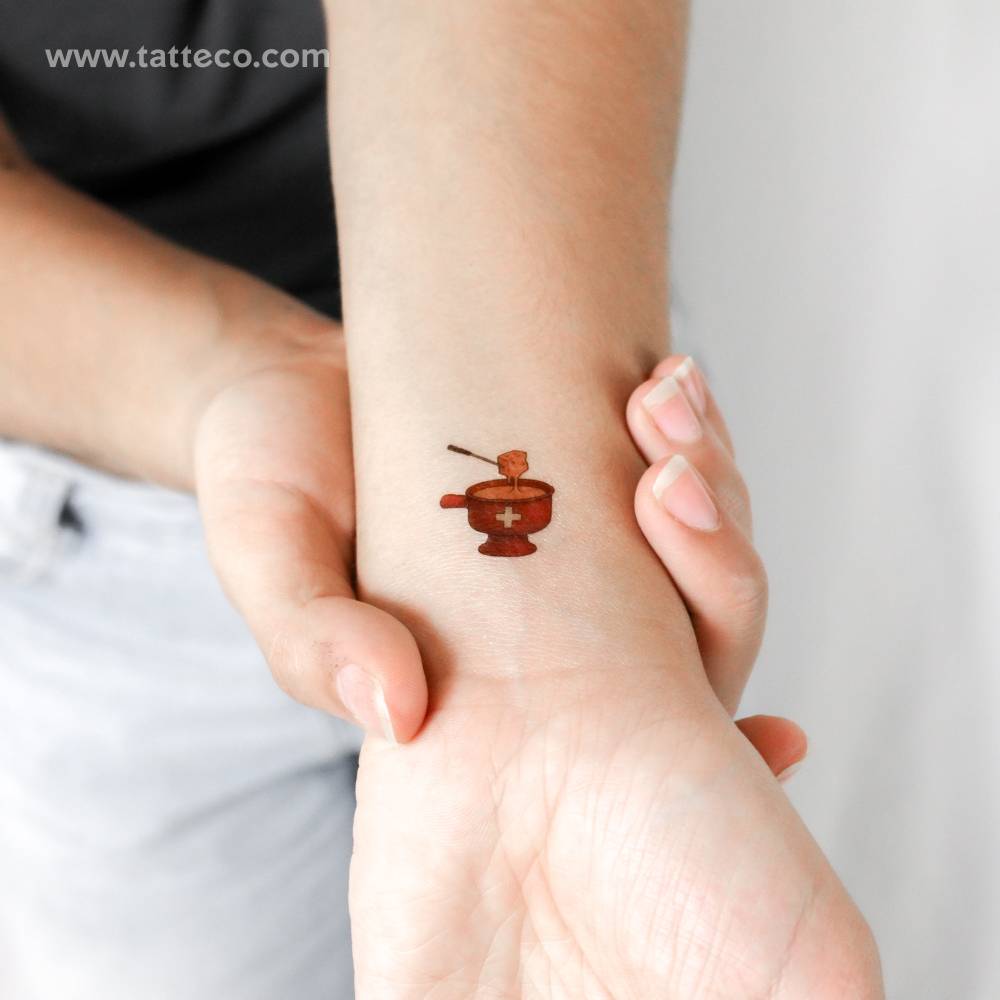 Illustrative style fondue temporary tattoo located on the wrist.