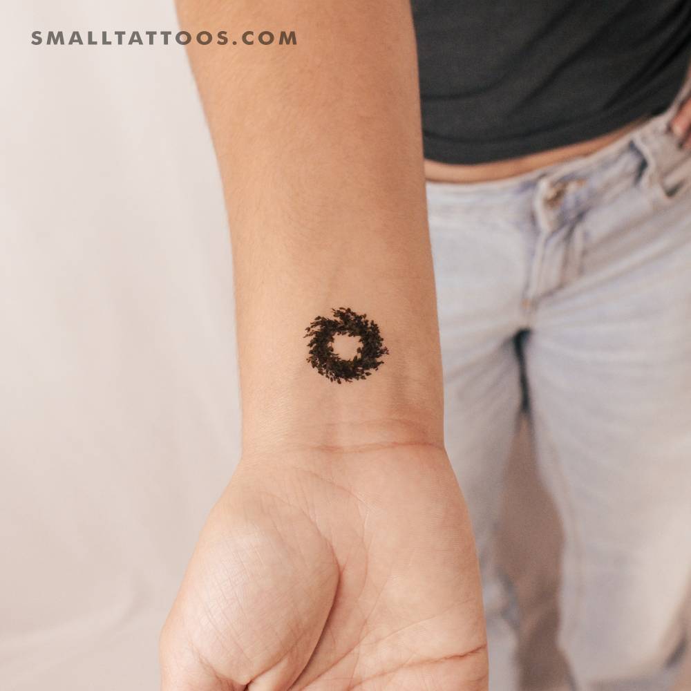 Mistletoe wreath temporary tattoo placed on the wrist.