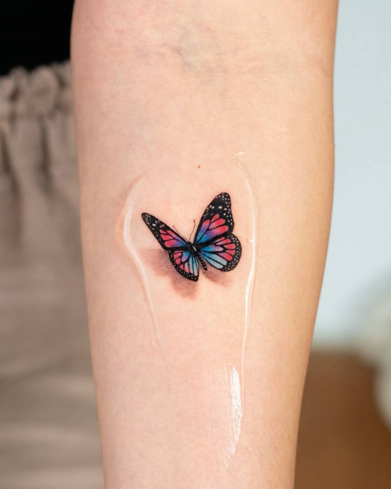 Butterfly tattoo in micro-realistic style located on the inner forearm.