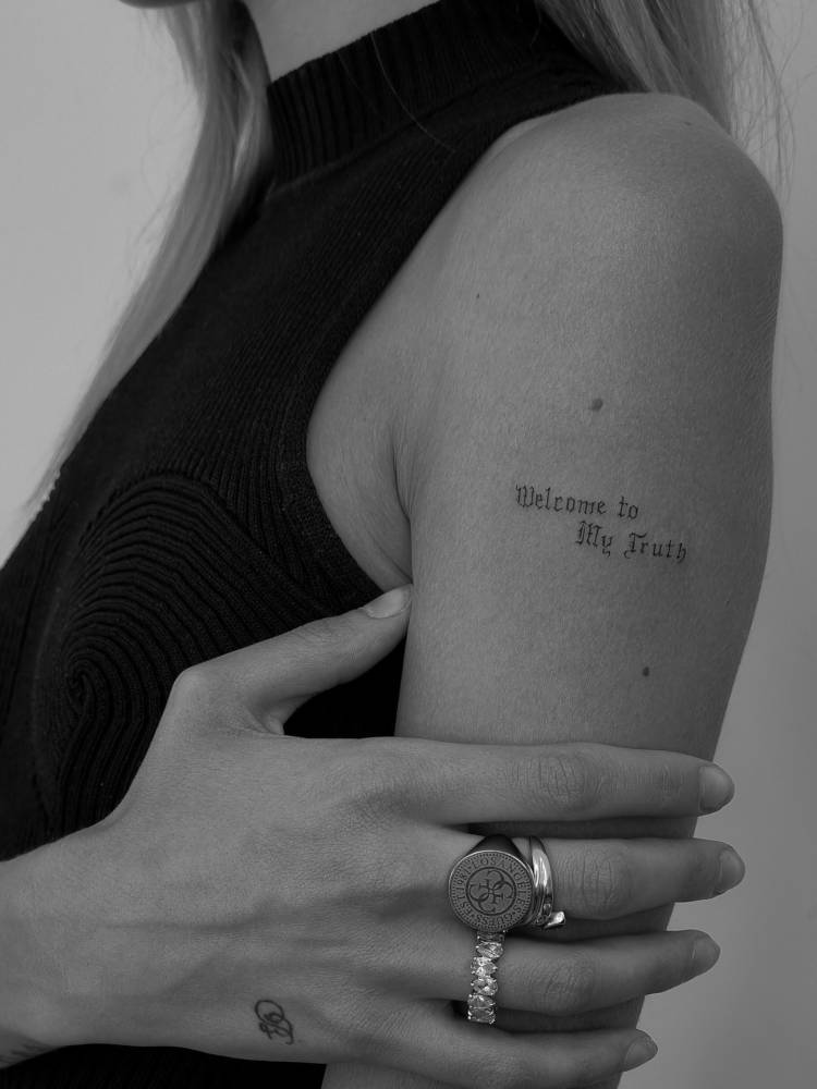 "Welcome to my truth" lettering tattoo in gothic font.