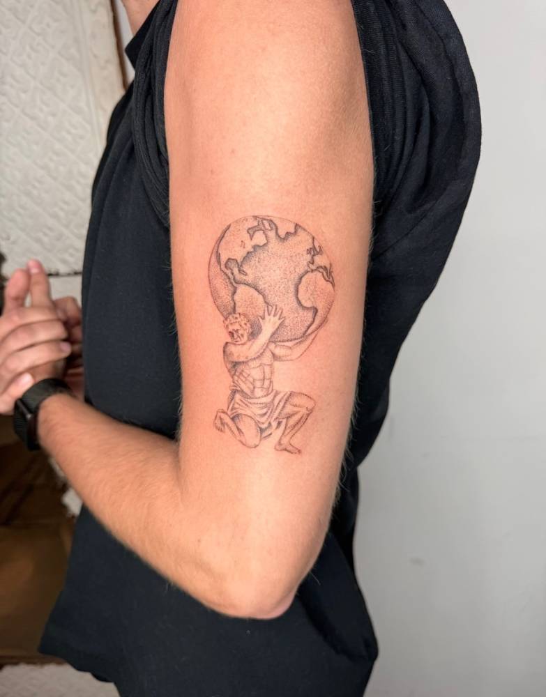 Atlas tattoo in illustrative style located on the upper arm.
