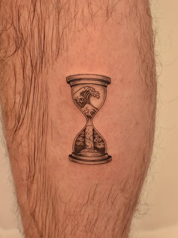 'The Great Wave' hourglass tattoo located on the calf.