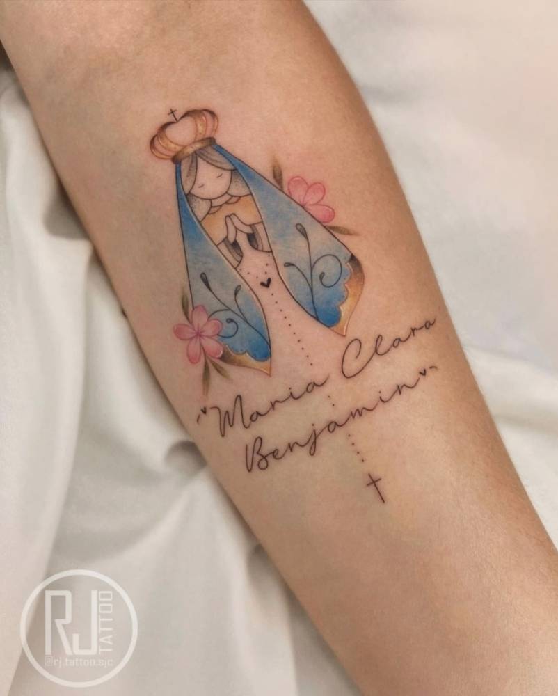 Our Lady of Aparecida and names "Maria Clara" and "Benjamin" tattooed on the inner forearm.