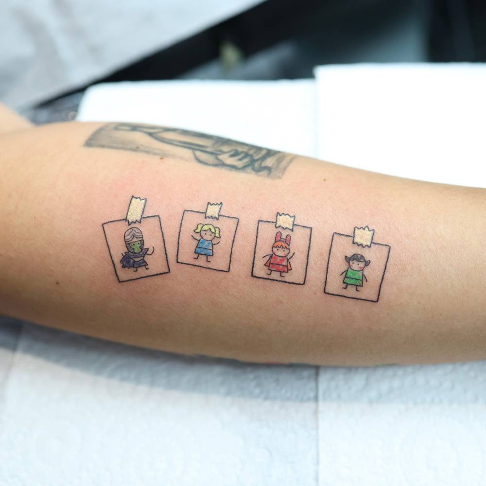 Powerpuff Girls tattoo located on the forearm, cartoon style.