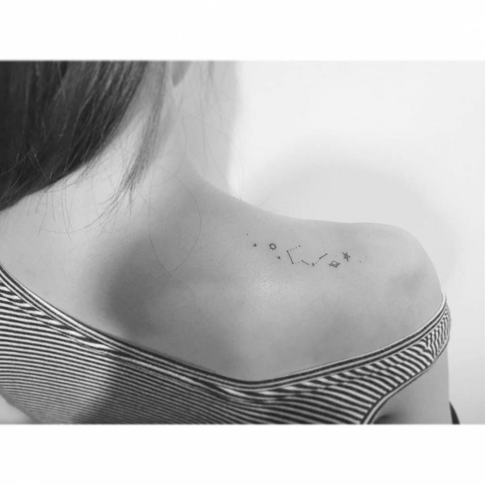 Little minimalistic galaxy tattoo located on the shoulder blade.,
