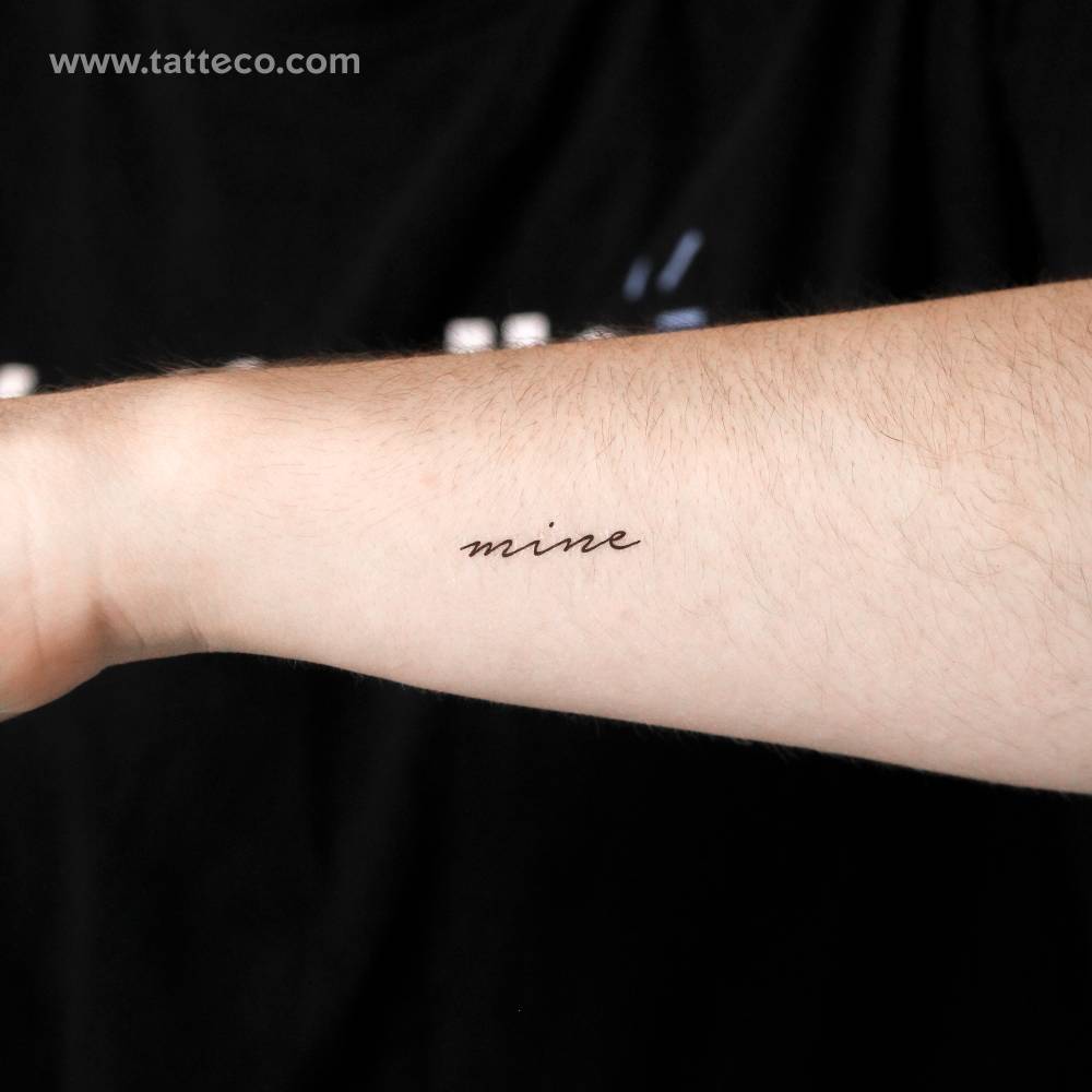 Handwritten font word "mine" temporary tattoo located on the wrist.
