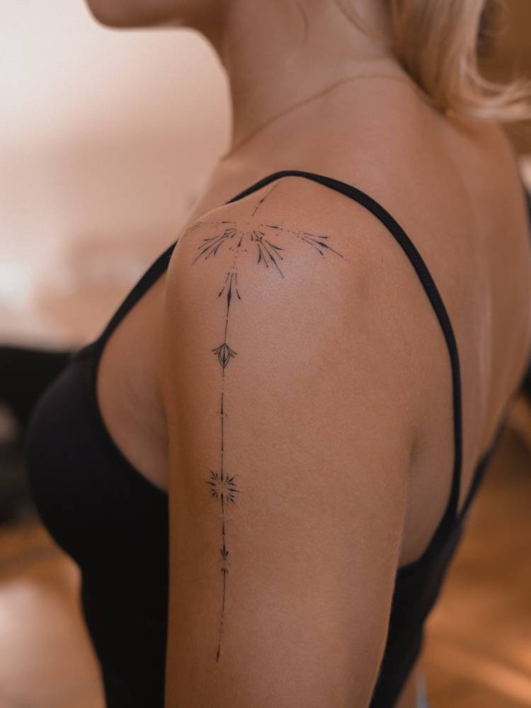 Hand poked ornamental design tattooed on the shoulder.