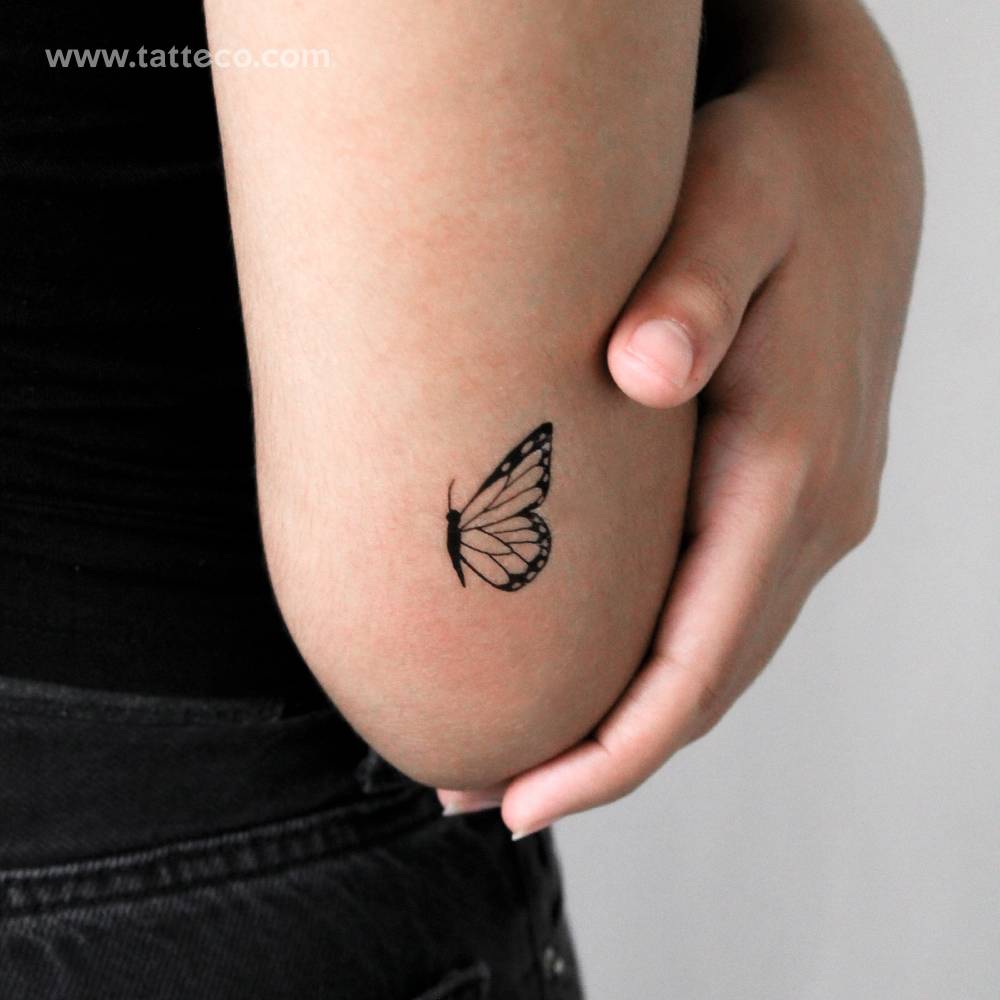 Half butterfly temporary tattoo located on the tricep.