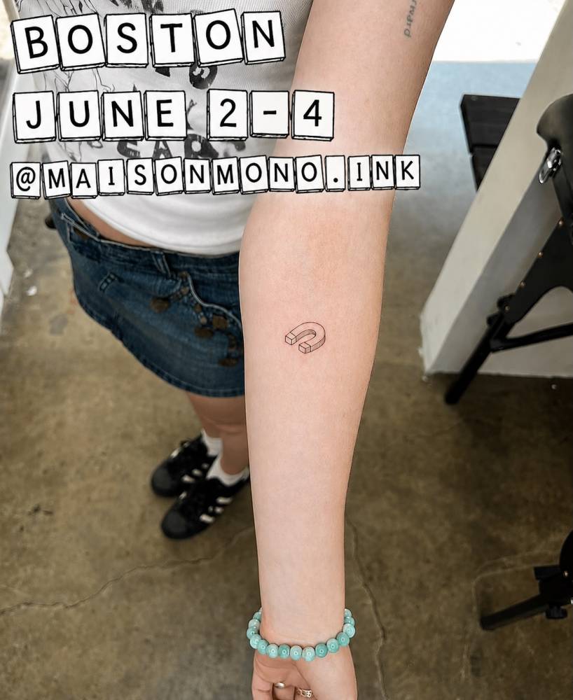 Magnet tattoo in fine line style done on the inner forearm.