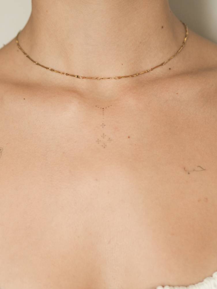 Ornamental design tattooed on the collarbone.