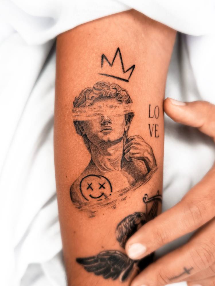 Pop art style Michelangelo's 'David' tattoo located on the forearm.