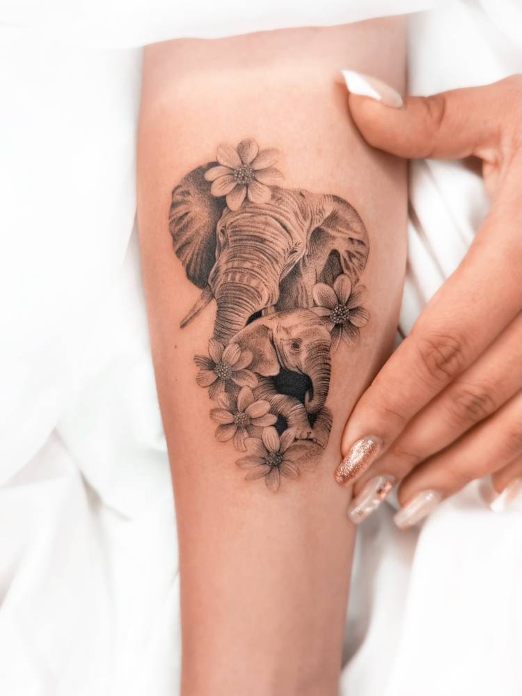 Elephant family tattoo located on the inner forearm.