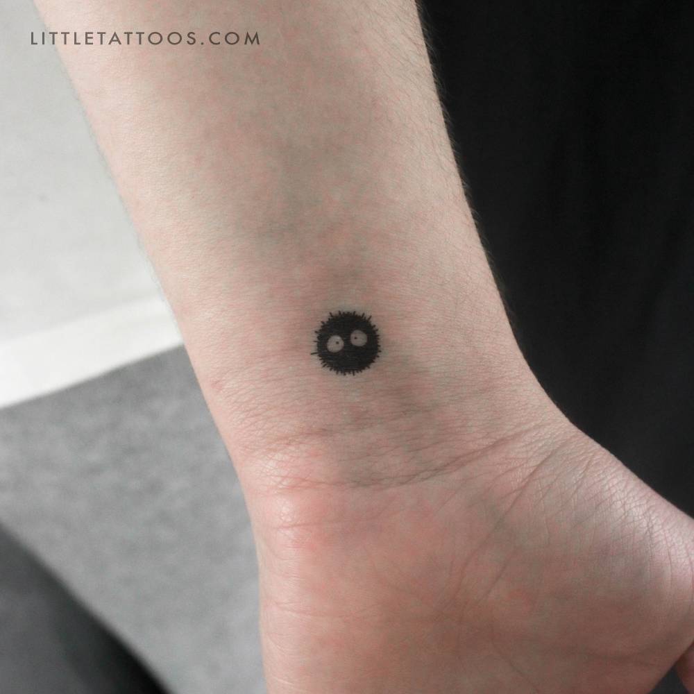 Cartoon style Soot Sprite temporary tattoo located on the wrist.